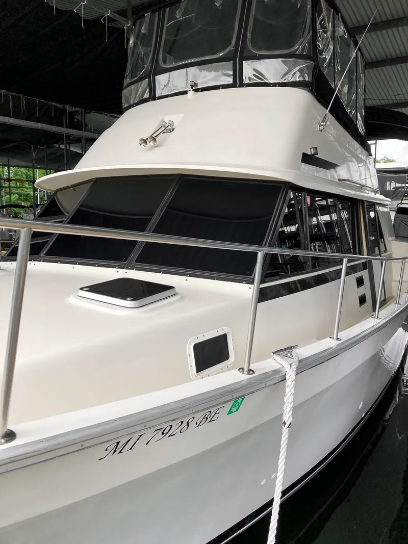 Slide: The Image of 1987 Mainship 40 Aft Cabin yacht docked in a covered marina. - 5