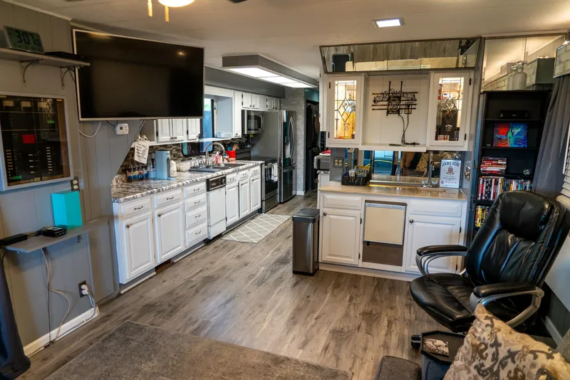 Slide: The Image of Interior of a 1991 Sumerset 65 x 14 Widebody Houseboat with modern kitchen and seating area. - 11