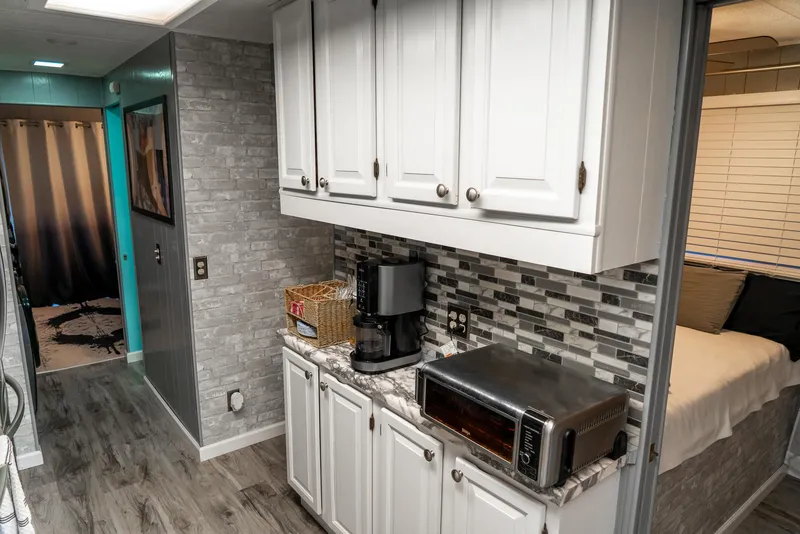 Slide: The Image of Interior of 1991 Sumerset 65 x 14 Widebody Houseboat with modern kitchen and cozy bedroom. - 20