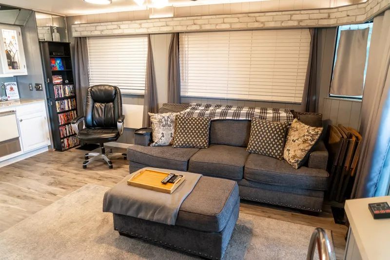 Slide: The Image of Cozy living area in a 1991 Sumerset 65 x 14 Widebody Houseboat with modern decor. - 3