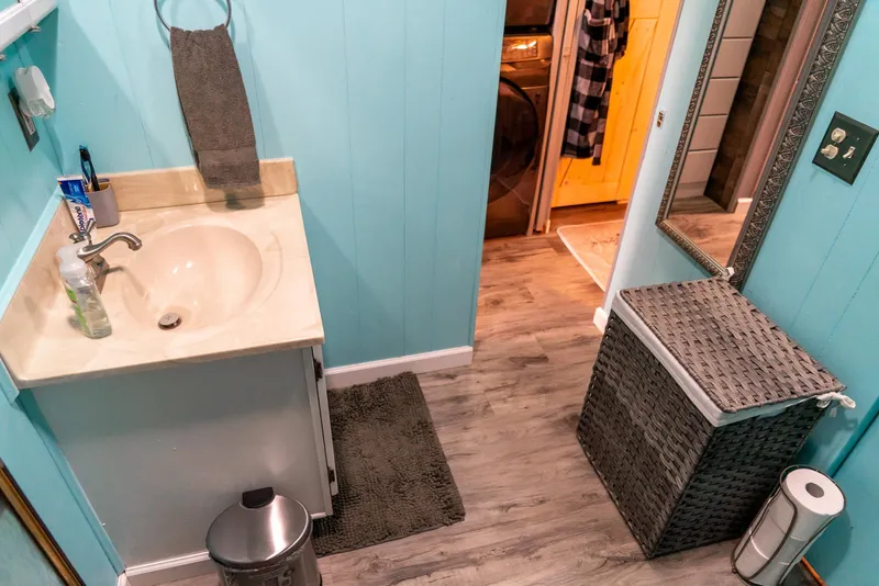 Slide: The Image of Bathroom in 1991 Sumerset 65 x 14 Widebody Houseboat with blue walls and wicker basket. - 30