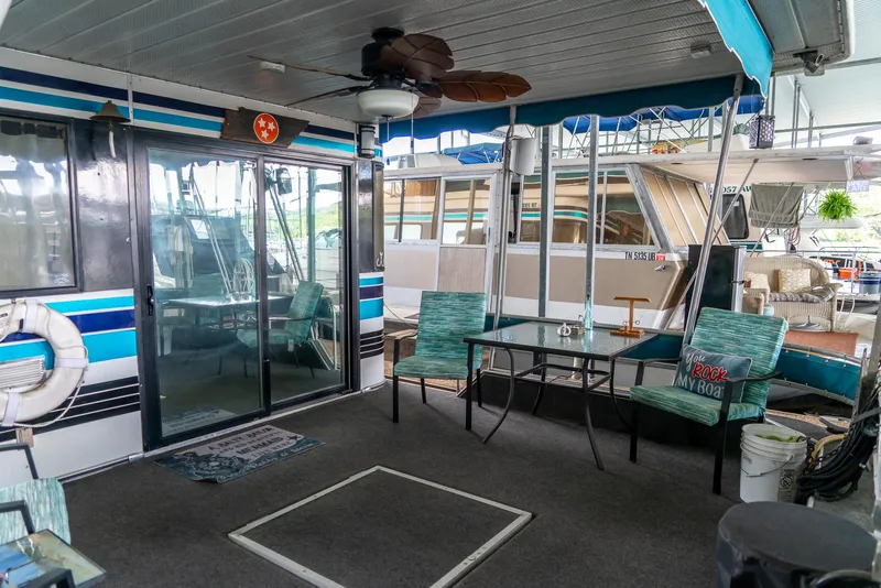 Slide: The Image of 1991 Sumerset 65 x 14 Widebody Houseboat interior with seating and decor. - 33