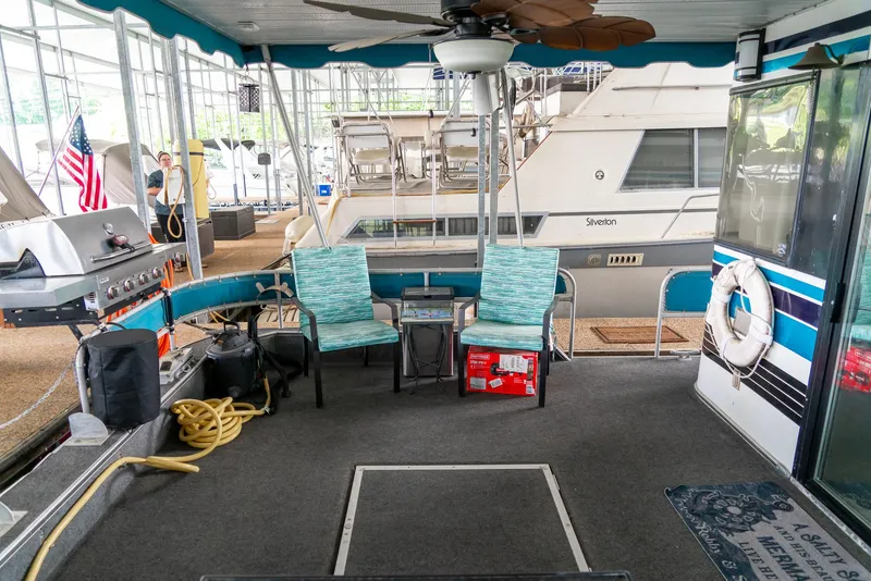 Slide: The Image of 1991 Sumerset 65 x 14 Widebody Houseboat interior with seating and grill. - 34