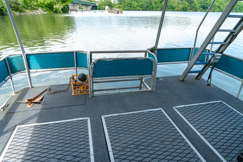 Slide: The Image of 1991 Sumerset 65 x 14 Widebody Houseboat deck with lake view and railing. - 38