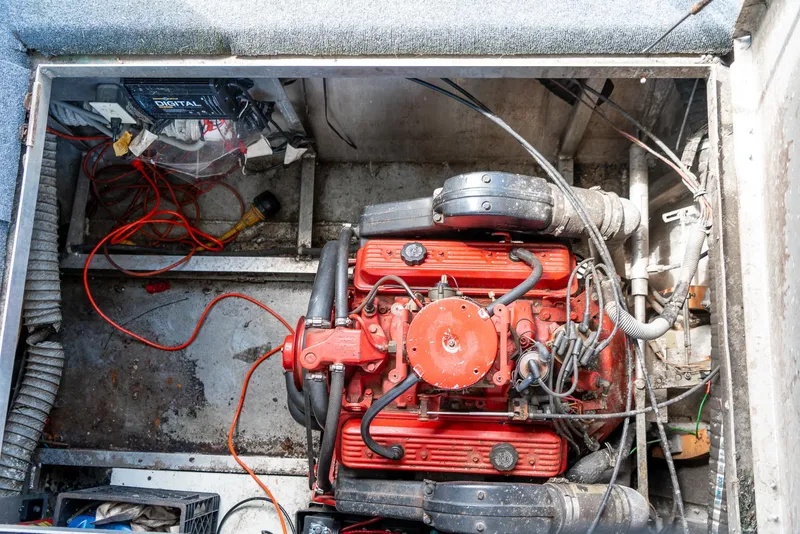 Slide: The Image of Engine compartment of a 1991 Sumerset 65 x 14 Widebody Houseboat, featuring a red engine. - 41