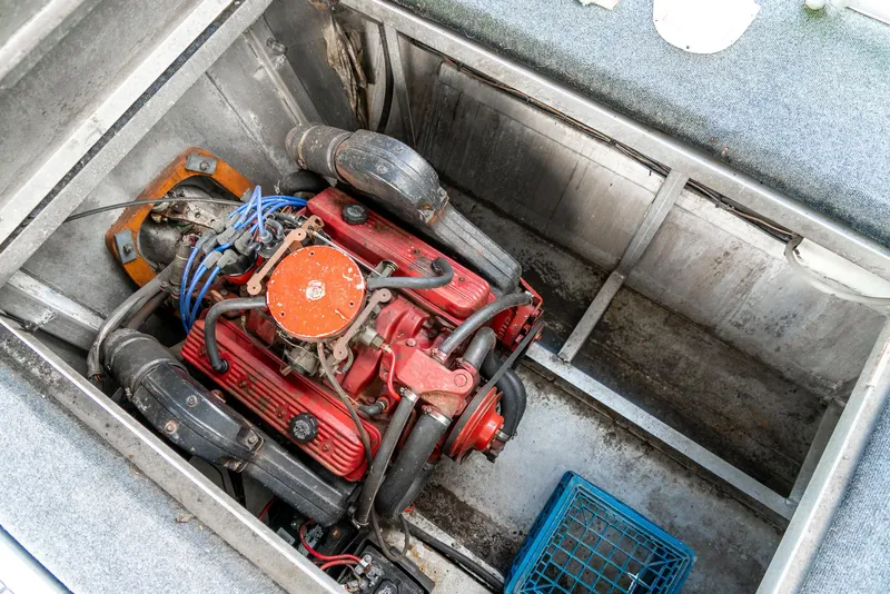 Slide: The Image of Engine compartment of a 1991 Sumerset 65 x 14 Widebody Houseboat, featuring a red engine. - 42