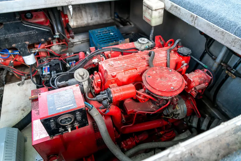Slide: The Image of Engine compartment of a 1991 Sumerset 65 x 14 Widebody Houseboat, featuring a red engine. - 43