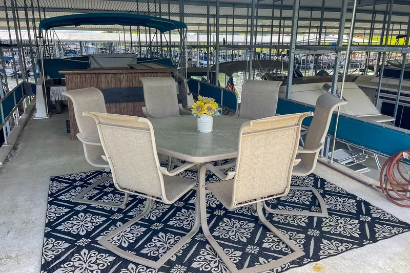 Slide: The Image of Outdoor seating on 1991 Sumerset 65 x 14 Widebody Houseboat with floral rug and table. - 45