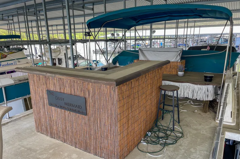 Slide: The Image of 1991 Sumerset 65 x 14 Widebody Houseboat with outdoor bar and seating area in marina. - 46