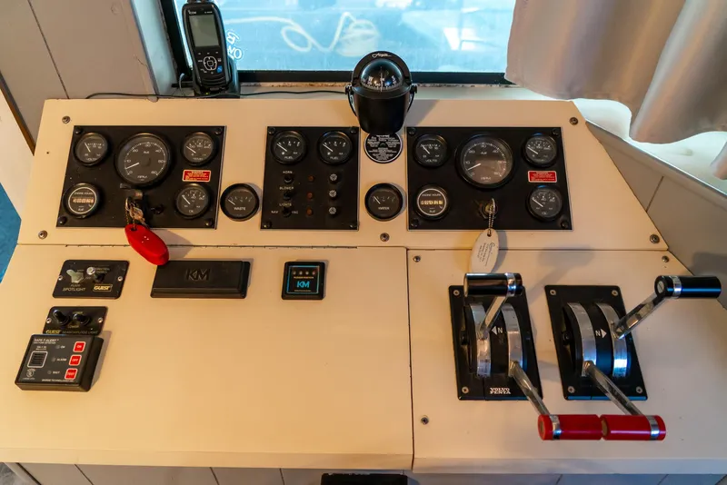 Slide: The Image of Control panel of a 1991 Sumerset 65 x 14 Widebody Houseboat with gauges and levers. - 8