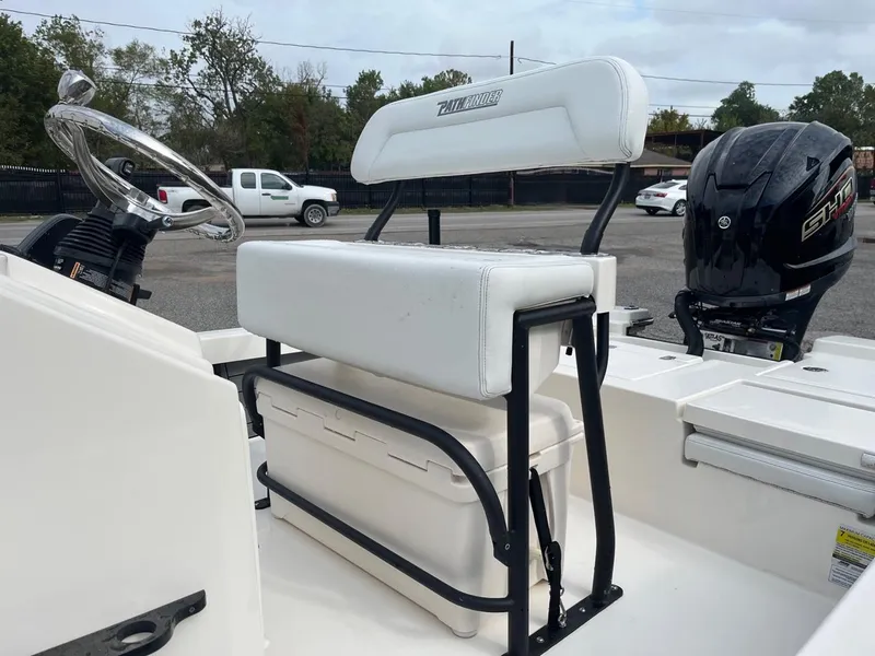 Slide: The Image of 2024 Pathfinder 2200 TRS boat interior with white seating and steering wheel. - 5