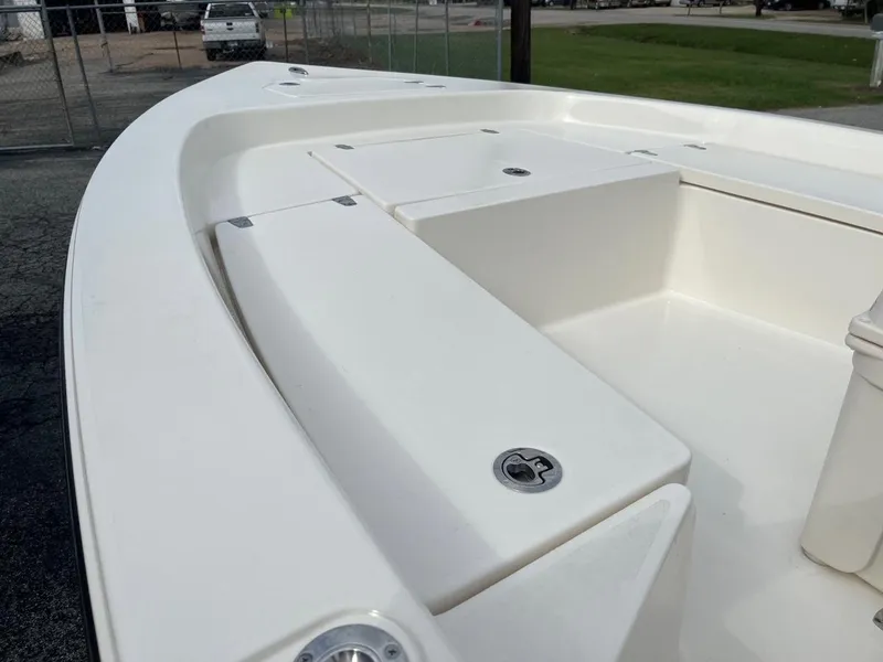 Slide: The Image of 2024 Pathfinder 2200 TRS boat interior, featuring sleek white seating and storage compartments. - 9
