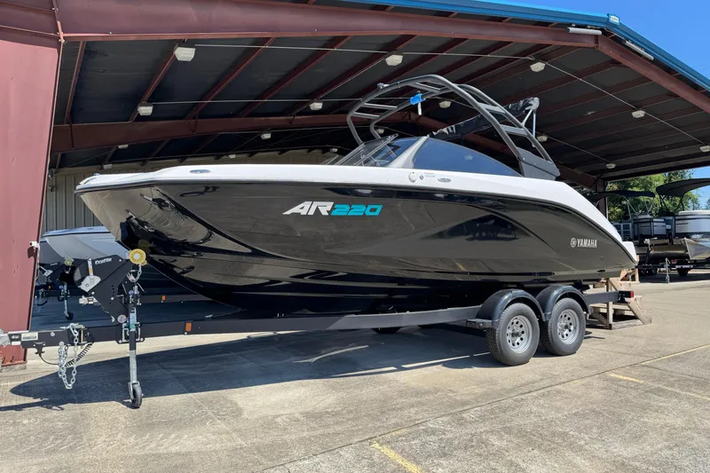 The Image of 2025 Yamaha Boats AR220 on trailer in covered storage area. - 0