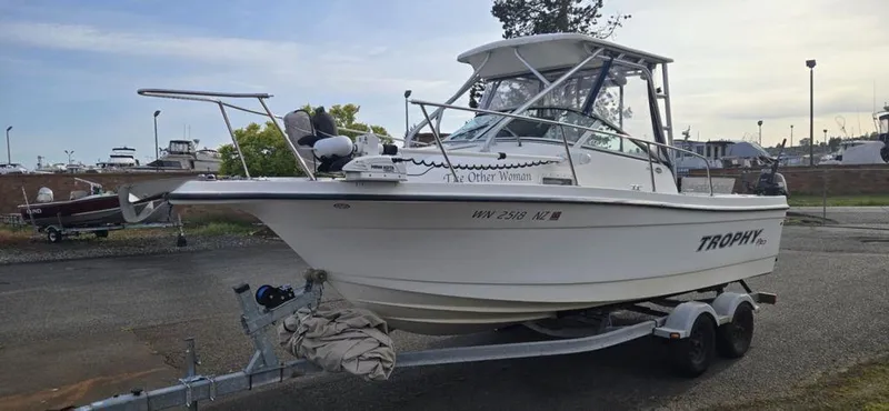 Slide: The Image of 2008 Trophy 2152WA boat on trailer in marina setting. - 11