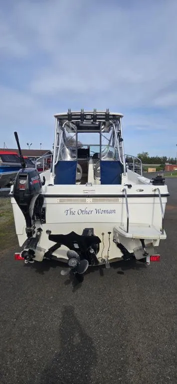 Slide: The Image of 2008 Trophy 2152WA boat, rear view, named "The Other Woman," parked on asphalt. - 13