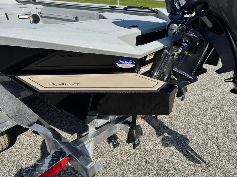 Slide: The Image of 2025 Avid 18 Commander boat on trailer, showcasing rear motor and sleek design. - 10