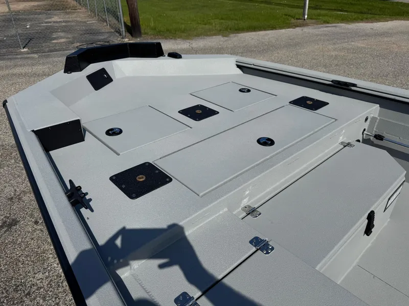 Slide: The Image of 2025 Avid 18 Commander boat deck with storage compartments and mounting points. - 13