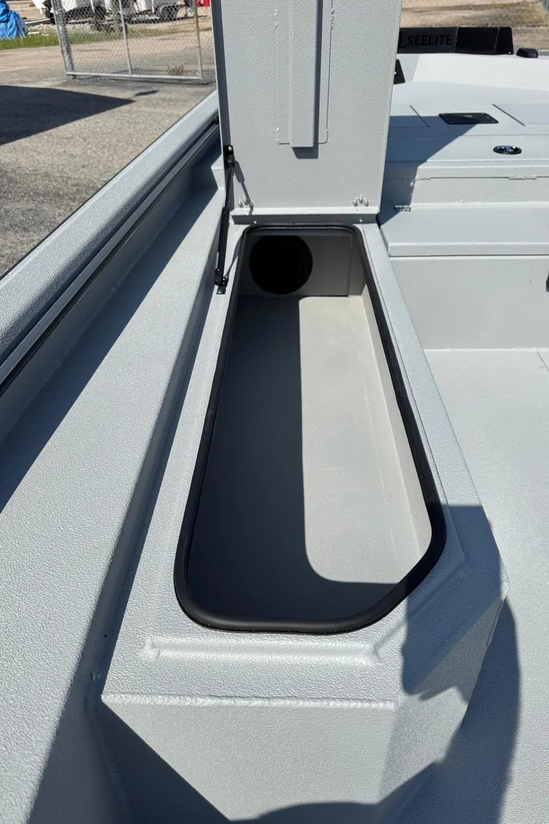 Slide: The Image of 2025 Avid 18 Commander boat storage compartment with open lid, showcasing interior space. - 14