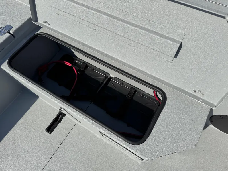 Slide: The Image of Battery compartment of 2025 Avid 18 Commander boat, featuring secure storage. - 15