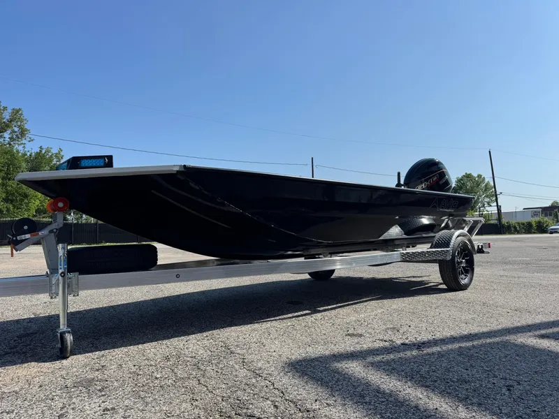 Slide: The Image of 2025 Avid 18 Commander boat on trailer, parked outdoors under clear blue sky. - 4