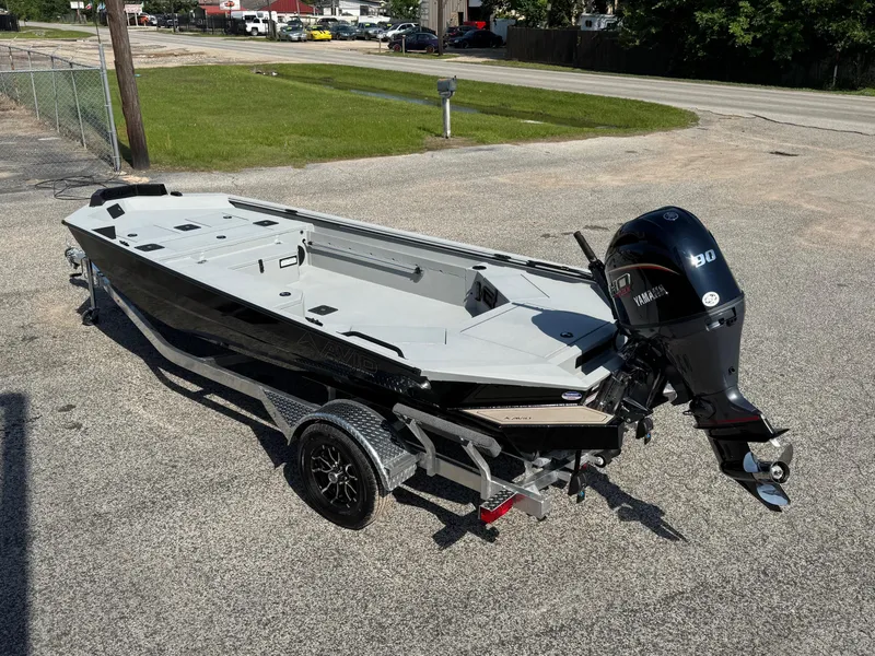 Slide: The Image of 2025 Avid 18 Commander boat with Yamaha motor on a trailer, parked outdoors. - 6