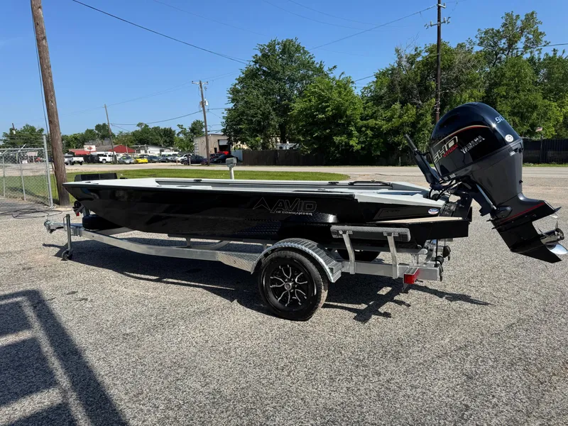 Slide: The Image of 2025 Avid 18 Commander boat on trailer, parked outdoors in a sunny area. - 7