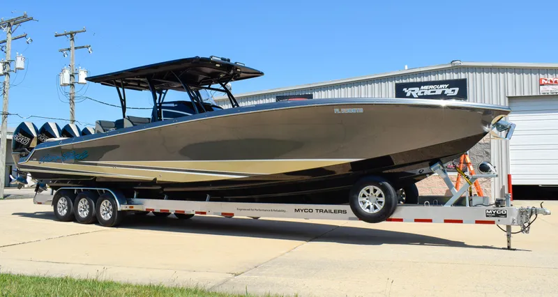 Slide: The Image of 2022 Nor-Tech 390 Sport boat on trailer outside a building. - 1