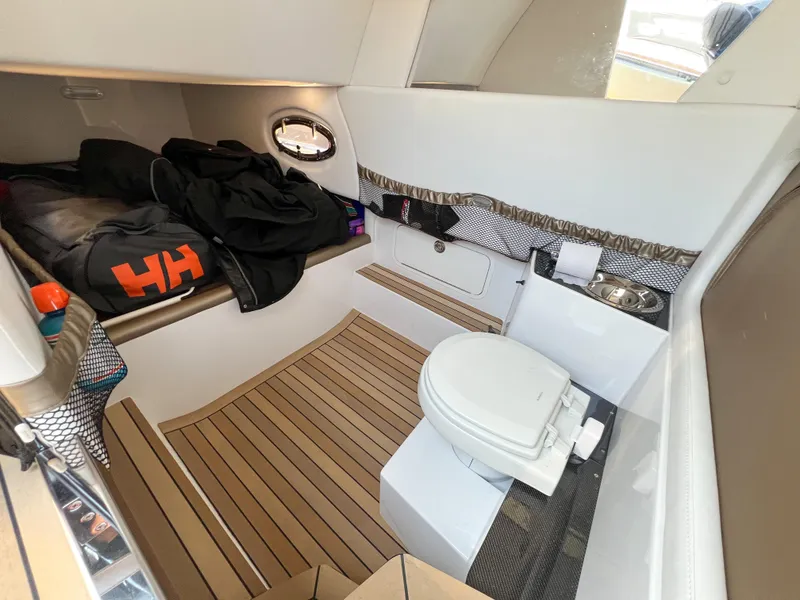 Slide: The Image of Interior cabin of 2022 Nor-Tech 390 Sport boat with toilet and storage area. - 10