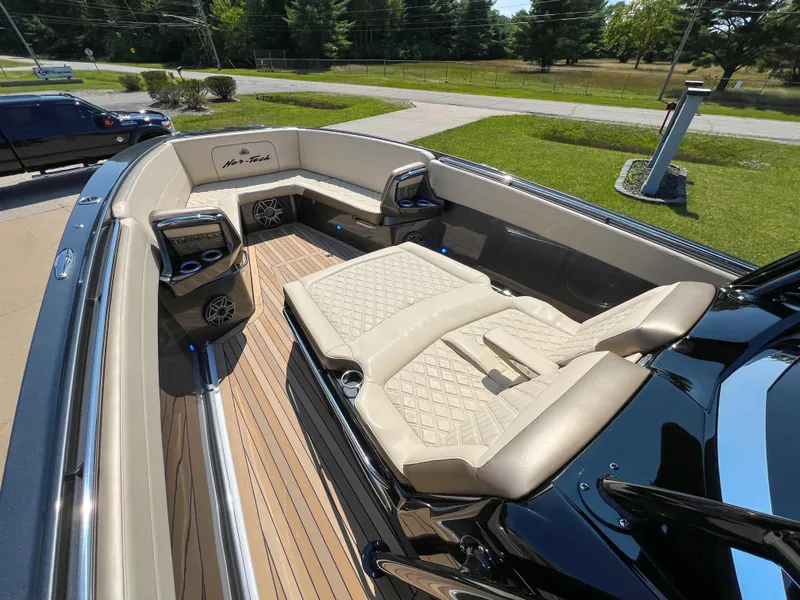 Slide: The Image of Luxurious 2022 Nor-Tech 390 Sport boat interior with beige seating and modern amenities. - 11
