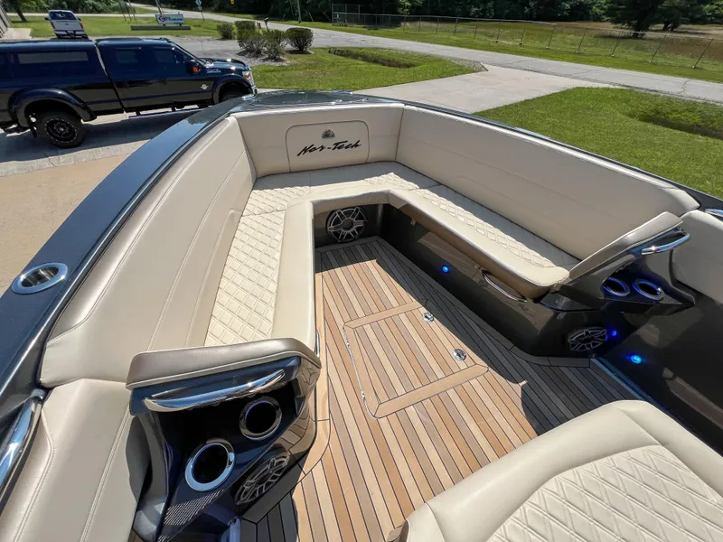 Slide: The Image of Luxurious 2022 Nor-Tech 390 Sport boat interior with beige seating and wood flooring. - 12