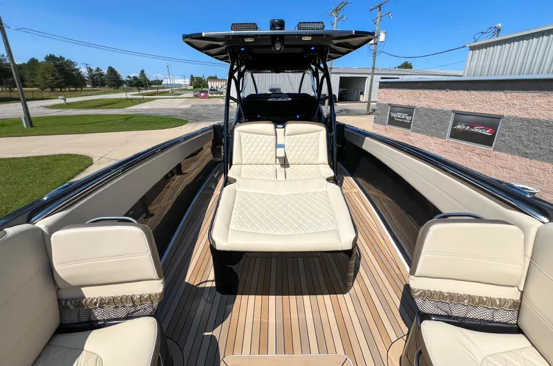 Slide: The Image of 2022 Nor-Tech 390 Sport boat with luxurious seating and sleek design. - 13