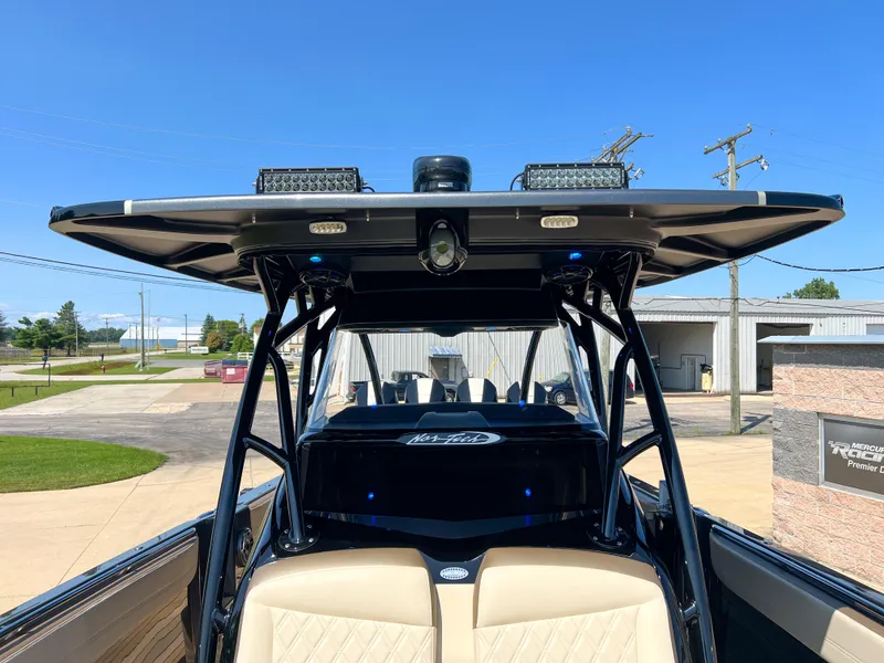 Slide: The Image of 2022 Nor-Tech 390 Sport boat with sleek design and modern features, docked outdoors. - 14