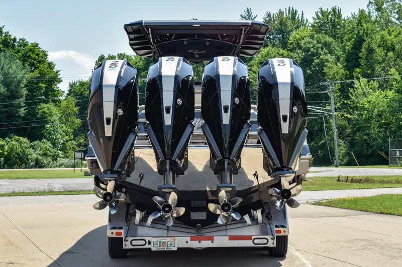 Slide: The Image of 2022 Nor-Tech 390 Sport boat with four powerful outboard engines, parked on a trailer. - 2