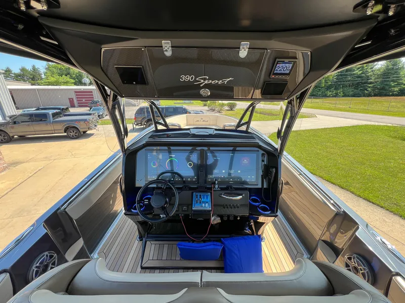 Slide: The Image of 2022 Nor-Tech 390 Sport boat cockpit with advanced navigation system and sleek design. - 4