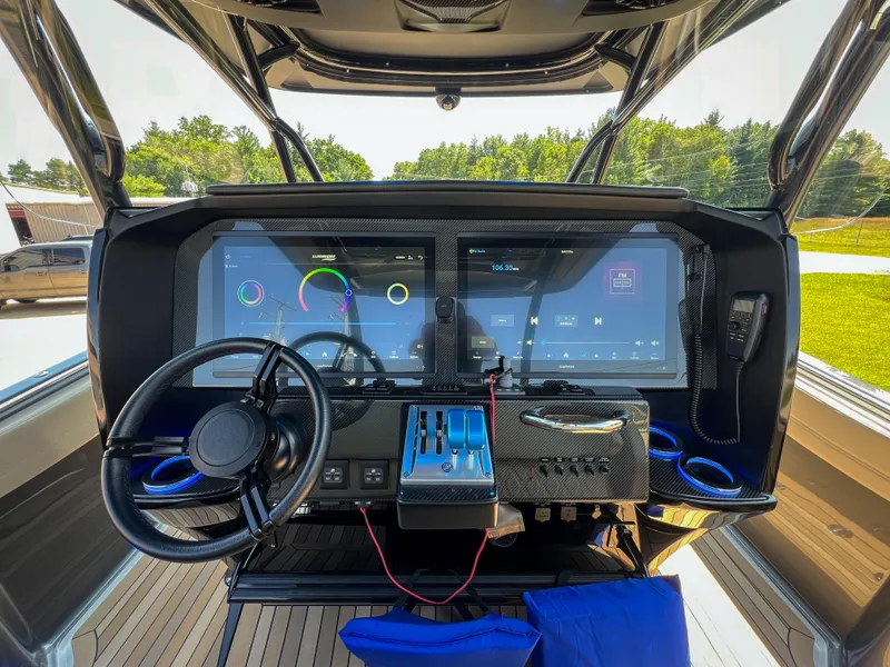 Slide: The Image of 2022 Nor-Tech 390 Sport boat dashboard with advanced digital controls and steering wheel. - 5