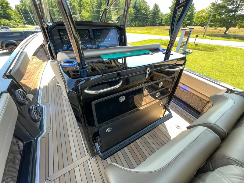 Slide: The Image of 2022 Nor-Tech 390 Sport boat interior with sleek dashboard and seating. - 6