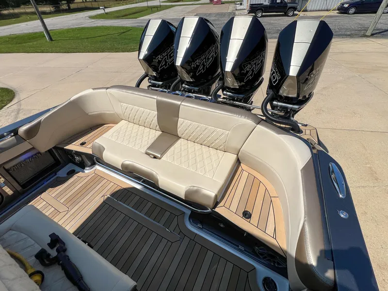 Slide: The Image of 2022 Nor-Tech 390 Sport boat with quad engines and luxurious seating on a wooden deck. - 7
