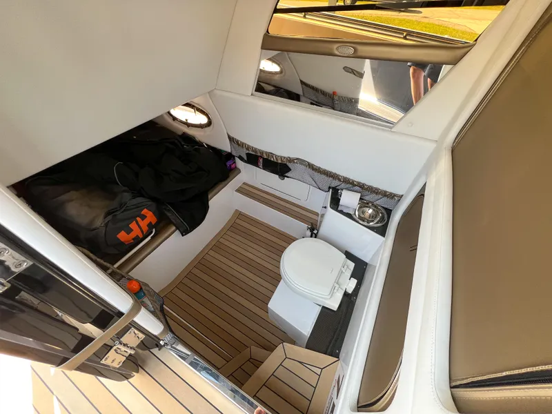 Slide: The Image of 2022 Nor-Tech 390 Sport cabin interior with toilet and wooden flooring. - 9