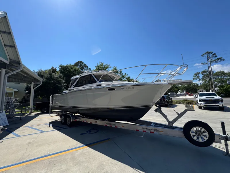 Slide: The Image of 2024 Cutwater C-288 Coupe boat on trailer under clear blue sky. - 10