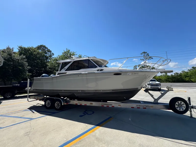 Slide: The Image of 2024 Cutwater C-288 Coupe boat on trailer in sunny parking lot. - 11