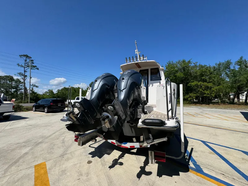 Slide: The Image of 2024 Cutwater C-288 Coupe boat with dual outboard motors on a trailer. - 16