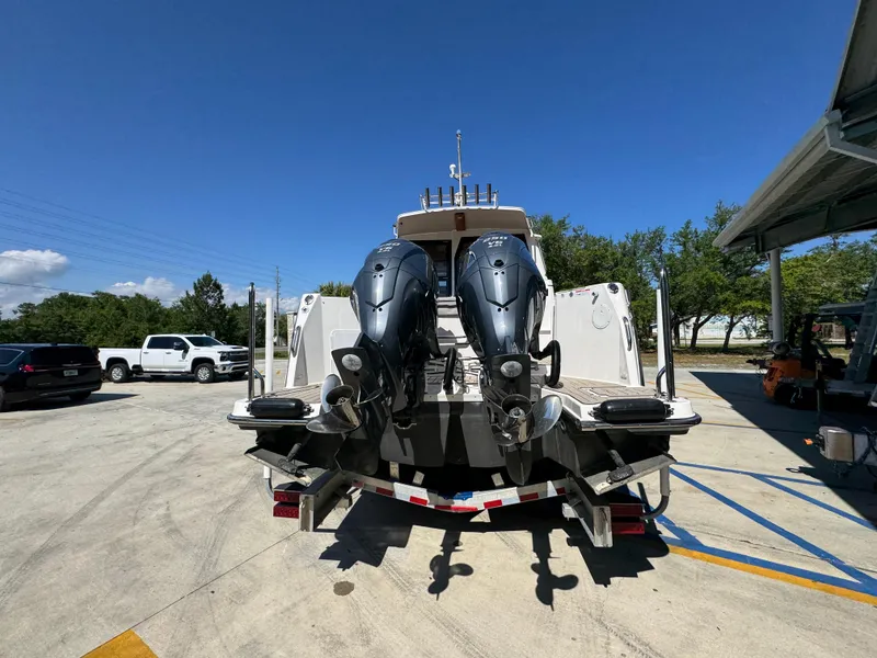 Slide: The Image of 2024 Cutwater C-288 Coupe boat with dual outboard motors on a trailer. - 17