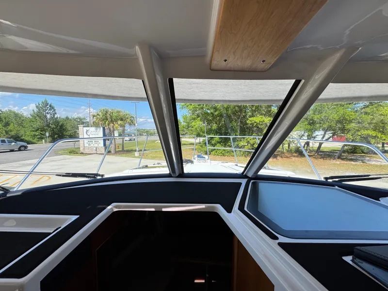 Slide: The Image of 2024 Cutwater C-288 Coupe interior view with large windows and modern dashboard. - 31