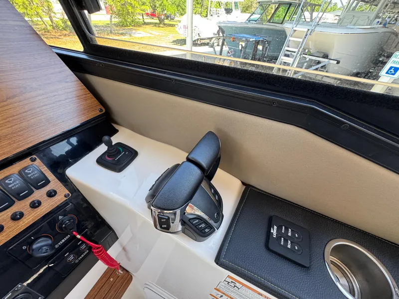 Slide: The Image of 2024 Cutwater C-288 Coupe helm controls with joystick and throttle, featuring modern design elements. - 34