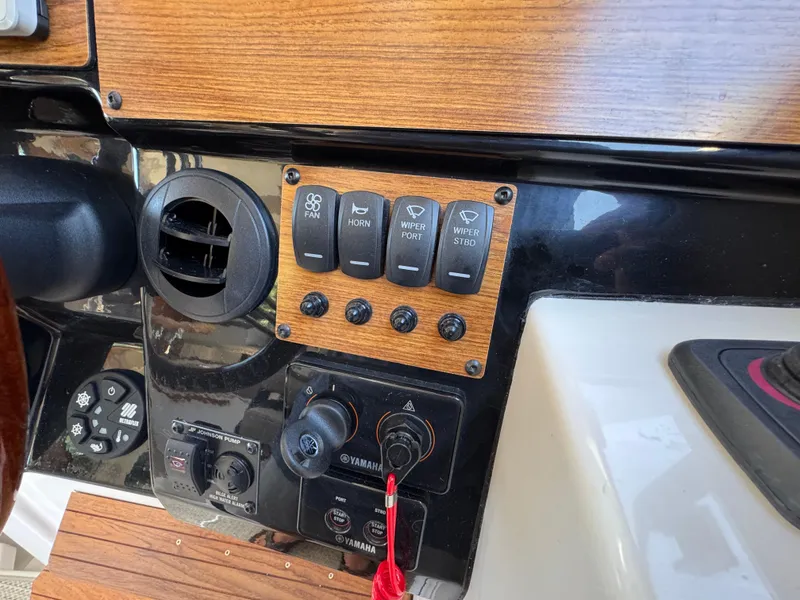 Slide: The Image of 2024 Cutwater C-288 Coupe dashboard with control panel and switches. - 36