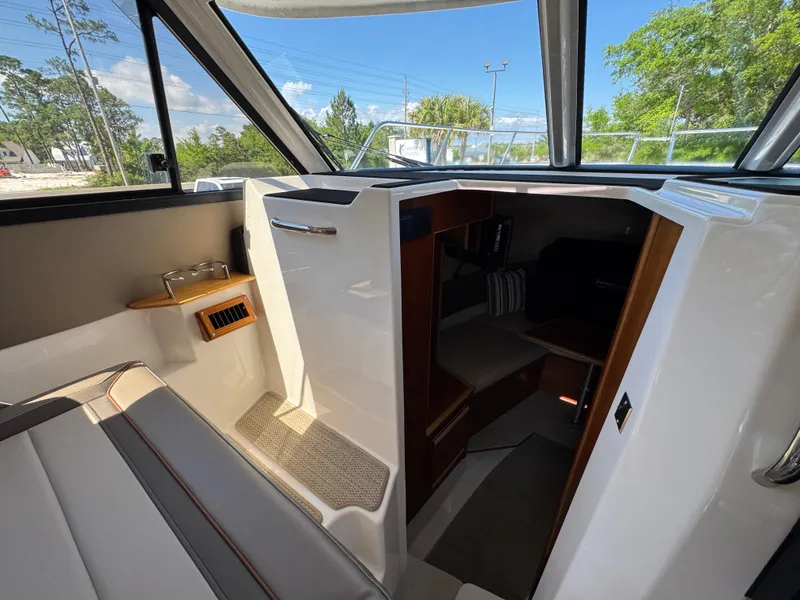 Slide: The Image of 2024 Cutwater C-288 Coupe interior with seating and cabin entrance. - 38