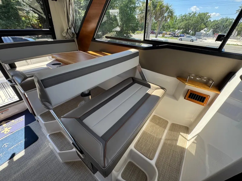 Slide: The Image of 2024 Cutwater C-288 Coupe interior with modern seating and large windows. - 39