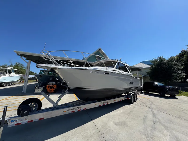 Slide: The Image of 2024 Cutwater C-288 Coupe boat on trailer under clear blue sky. - 4