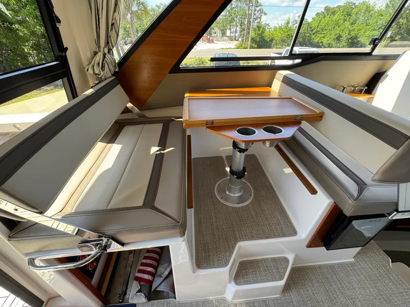 Slide: The Image of 2024 Cutwater C-288 Coupe interior with seating and table, featuring modern design and natural light. - 42