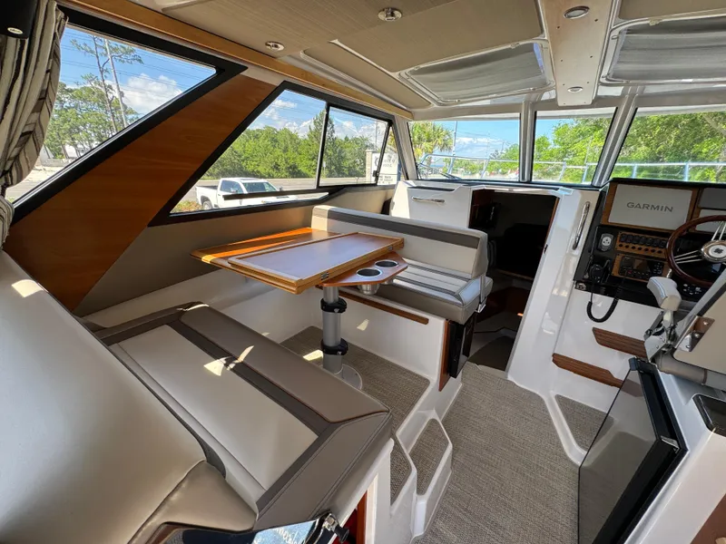 Slide: The Image of 2024 Cutwater C-288 Coupe interior with seating, table, and navigation equipment. - 43